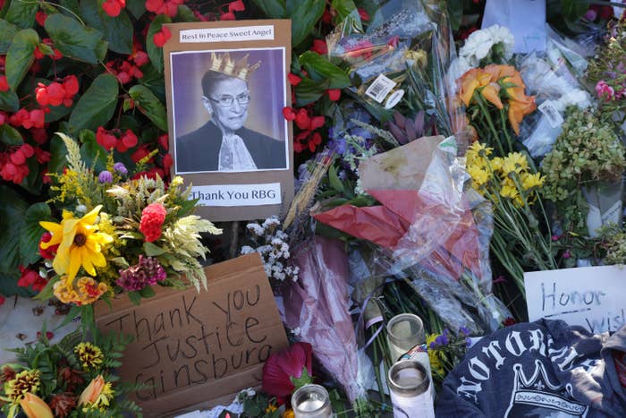 Makeshift memorial to Ruth Bader Ginsburg filled with flowers, candles, and cards