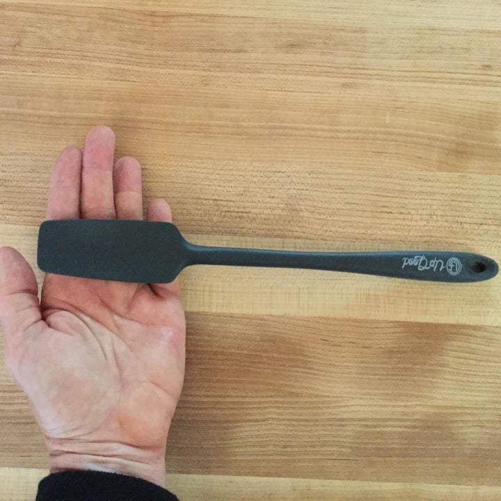 Reviewer shot of hand holding spatula