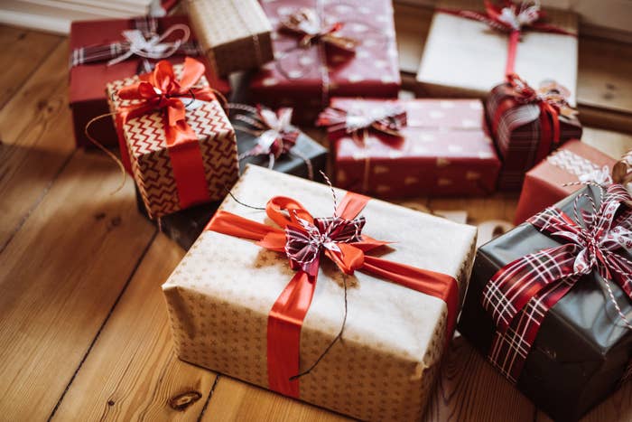 A collection of gift boxes in holiday wrapping paper and ribbons