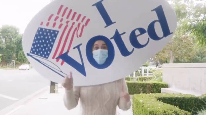 Katy Perry wearing a mask and a foam &#x27;&#x27;I voted&#x27;&#x27; sticker on her head