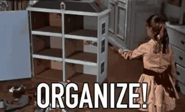 A GIF of a child snapping their fingers and all their dollhouse toys magically organize themselves