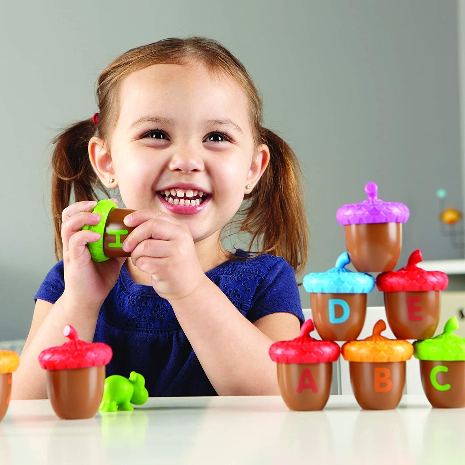 Child model with multi-colored toy acorns