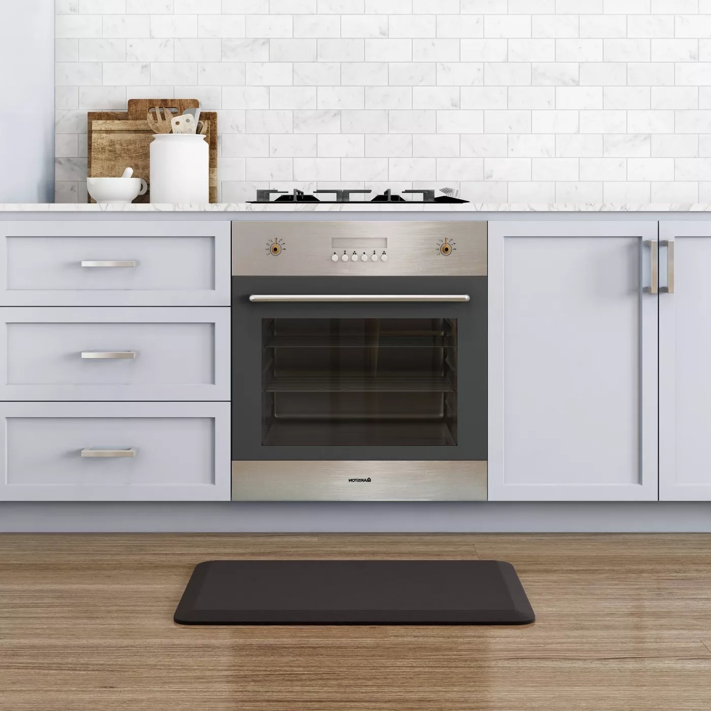 A black mat placed in front of a stove