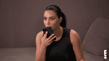 Kim Kardashian speaking to someone on speakerphone 