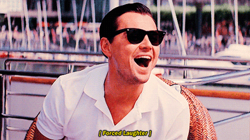Leonardo DiCaprio laughs with the caption, &quot;Forced laughter&quot; in Wolf of Wall Street