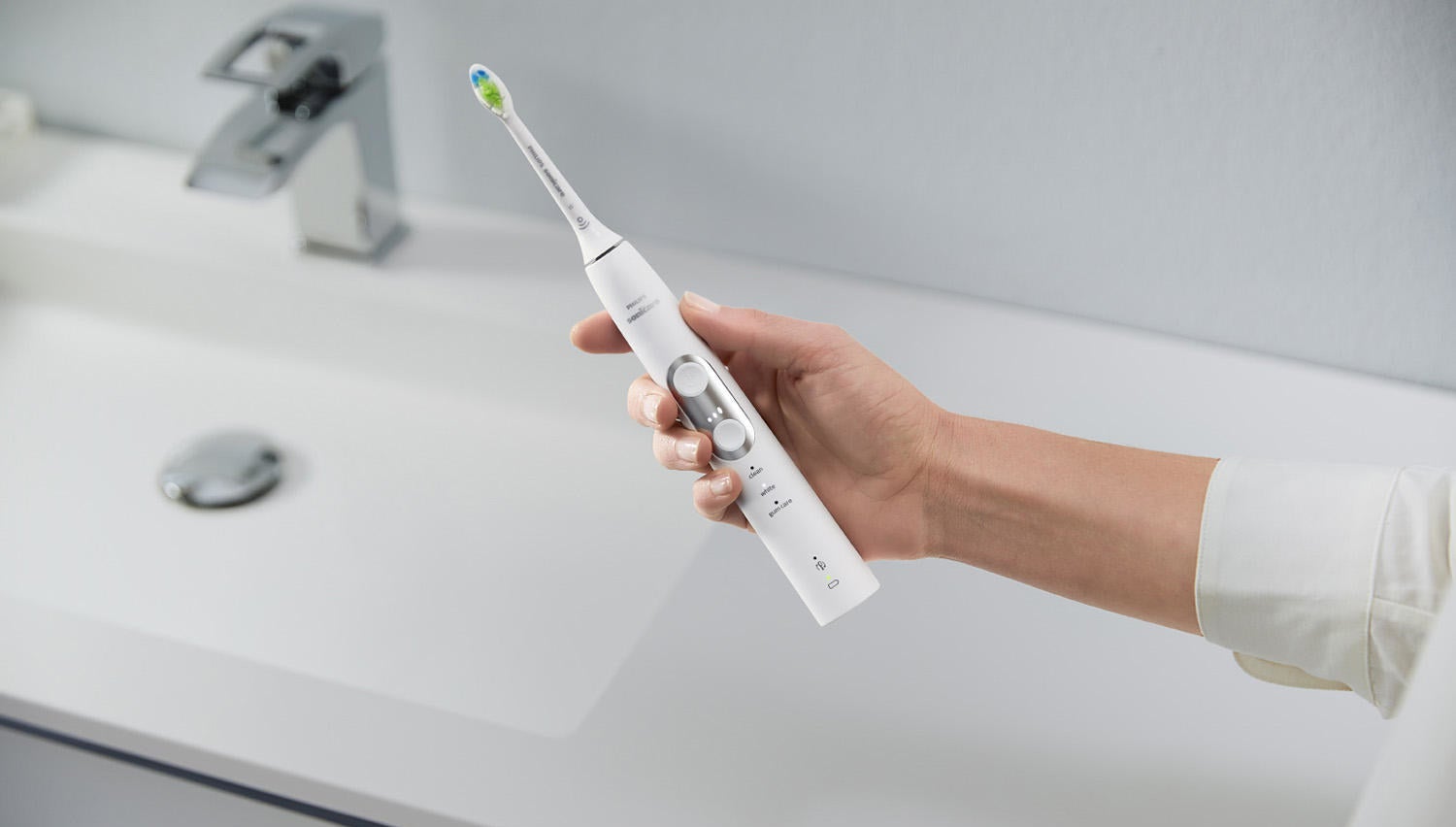 a model holding the toothbrush