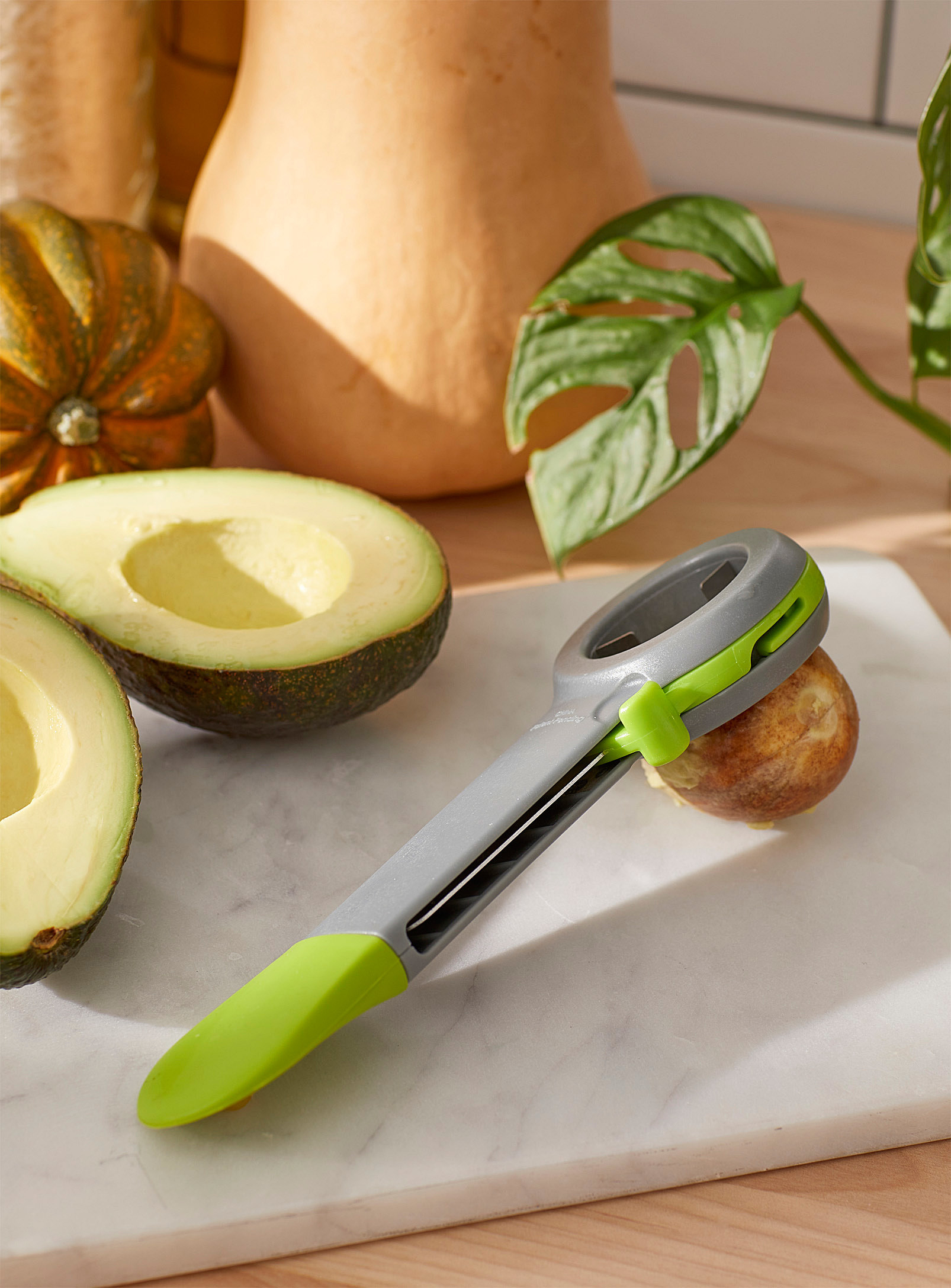 A tool takes a pit out of an avocado