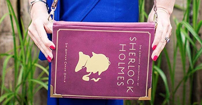 Book shaped purse in red with gold lettering &quot;Sherlock Holmes&quot; and silhouette of Sherlock smoking a pipe 