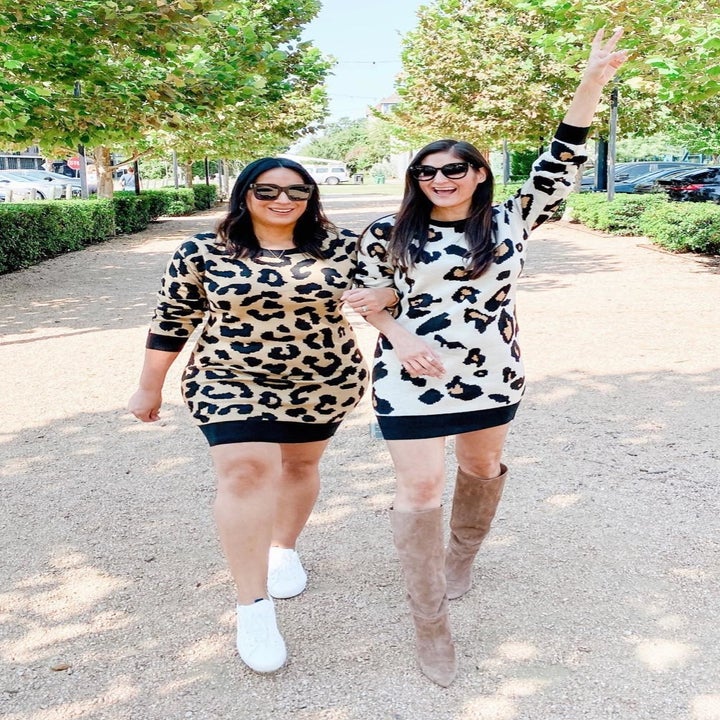 A different reviewer and friend wearing the sweater dresses in brown and white cheetah print