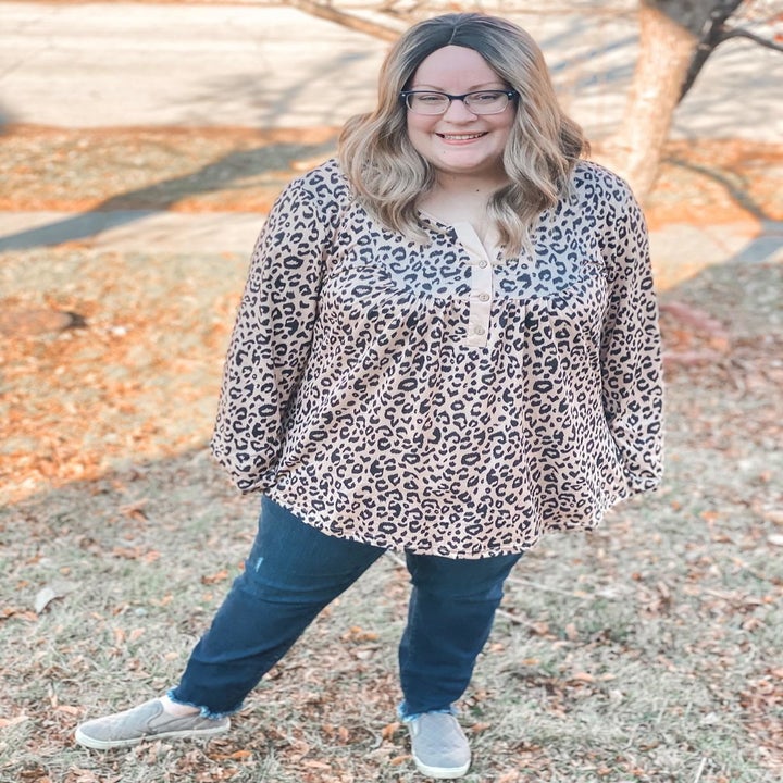 A different reviewer wearing the blouse in tan leopard print