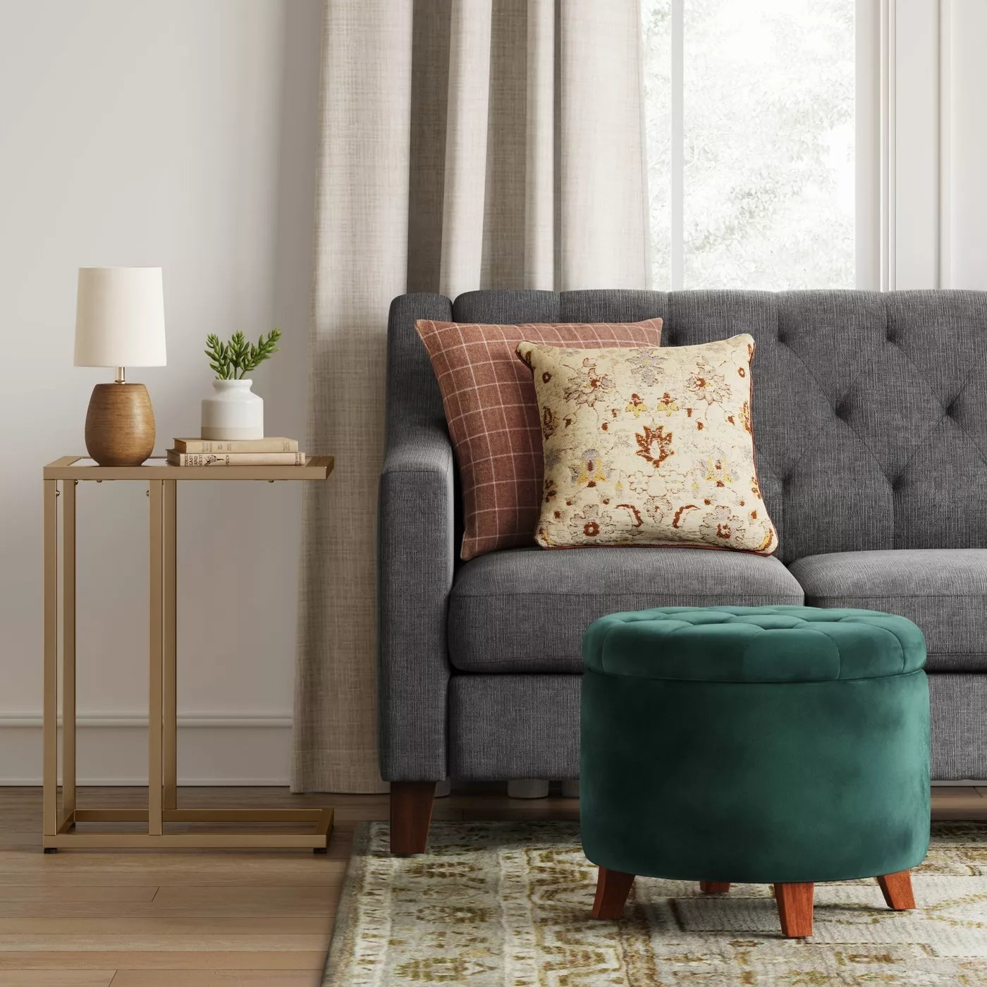 A green ottoman placed before a couch, lid closed
