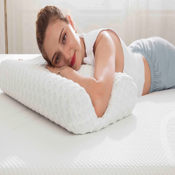 Model sleeping on their stomach with head on memory foam pillow