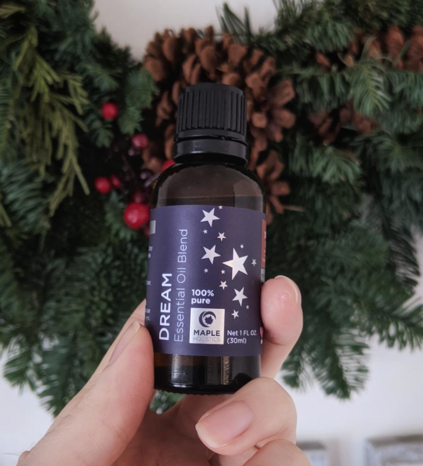 Reviewer holding a bottle of &quot;Dream&quot; essential oil blend