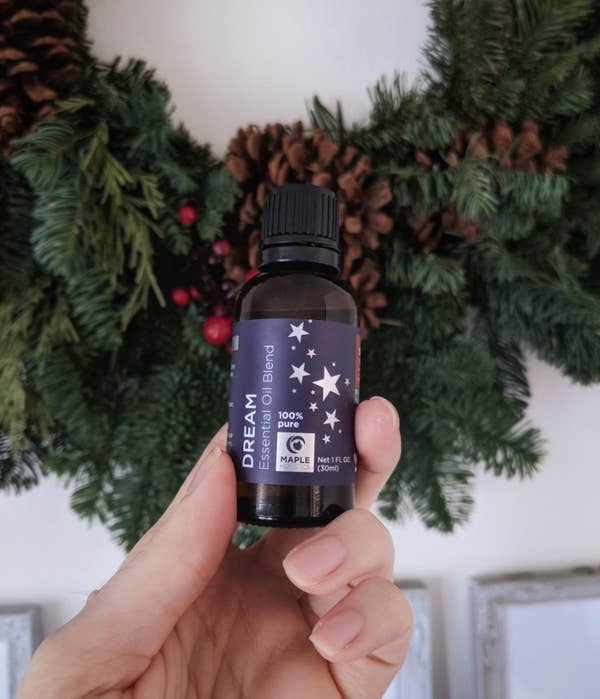 Reviewer holding a bottle of &quot;Dream&quot; essential oil blend