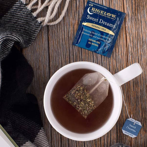 A cup of brewed tea with a Sweet Dreams herbal tea bag in it 