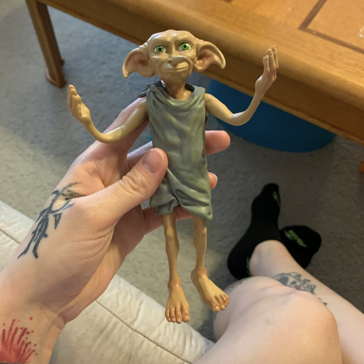 reviewer holding Dobby figure 