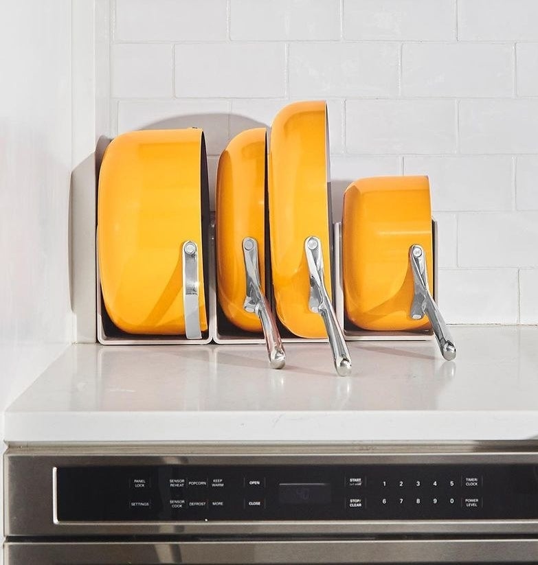 the pots and pans in their shelving in marigold