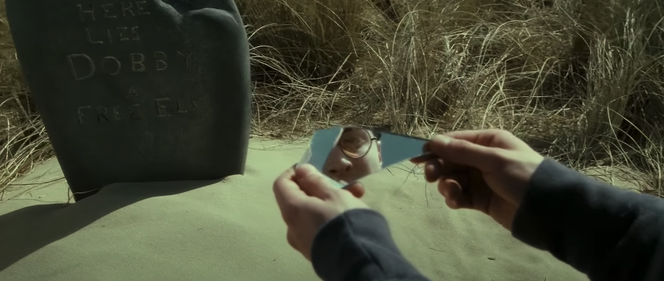 Harry looking at the two-way mirror in &quot;Deathly Hallows: Part 2&quot; near Dobby&#x27;s grave