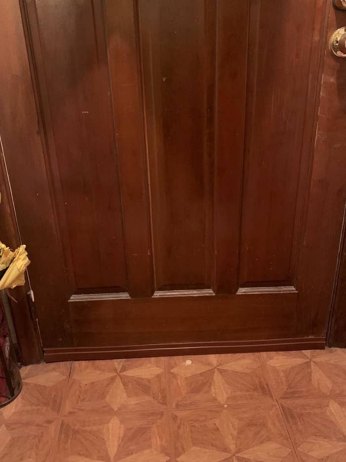 review image of draft blocker blending in on dark wood door