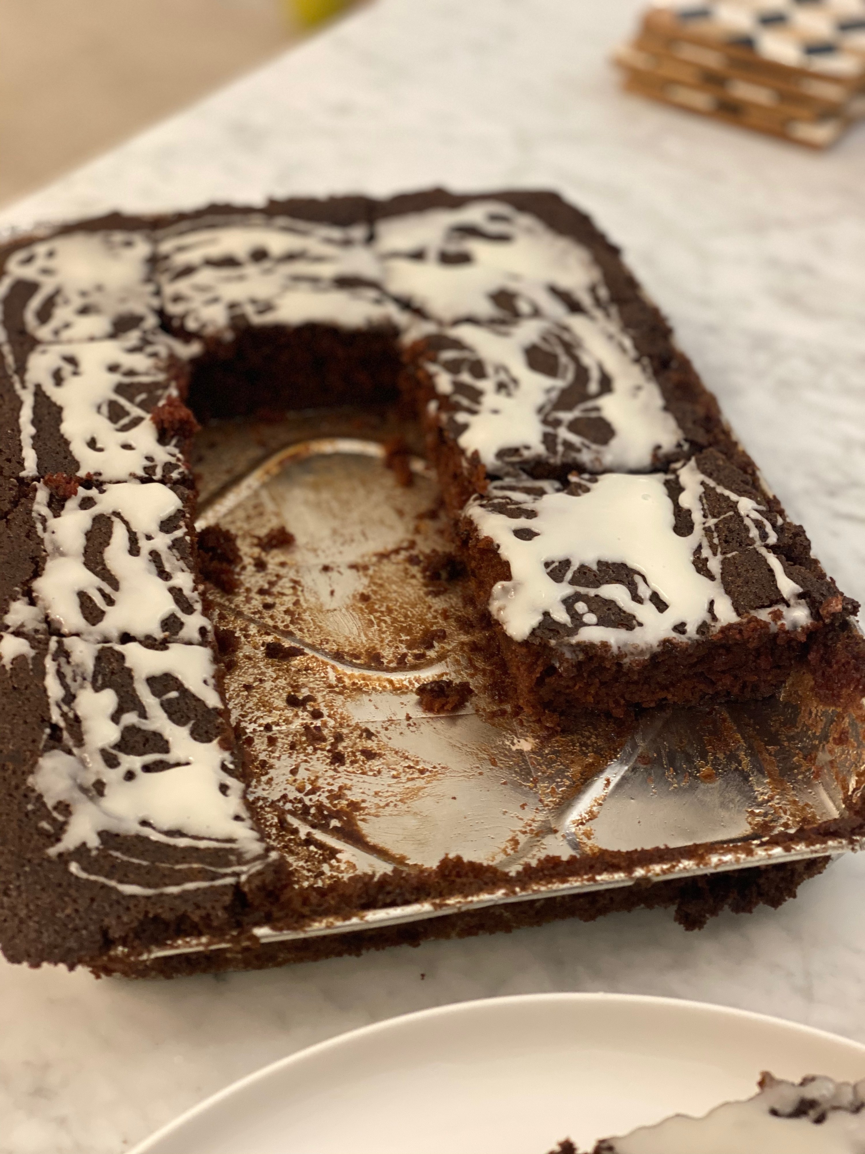 An interior shot of nana&#x27;s devil&#x27;s food cake with some slices missing.