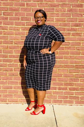 A reviewer wearing the elbow-length-sleeve dress in navy and white windowpane print
