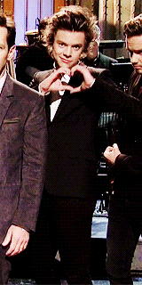 Harry doing a heart gesture with his hands on SNL