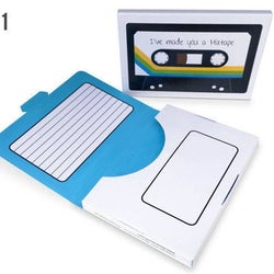 the flash drive sitting next to an open gift box, showing spots to write a track list and other notes