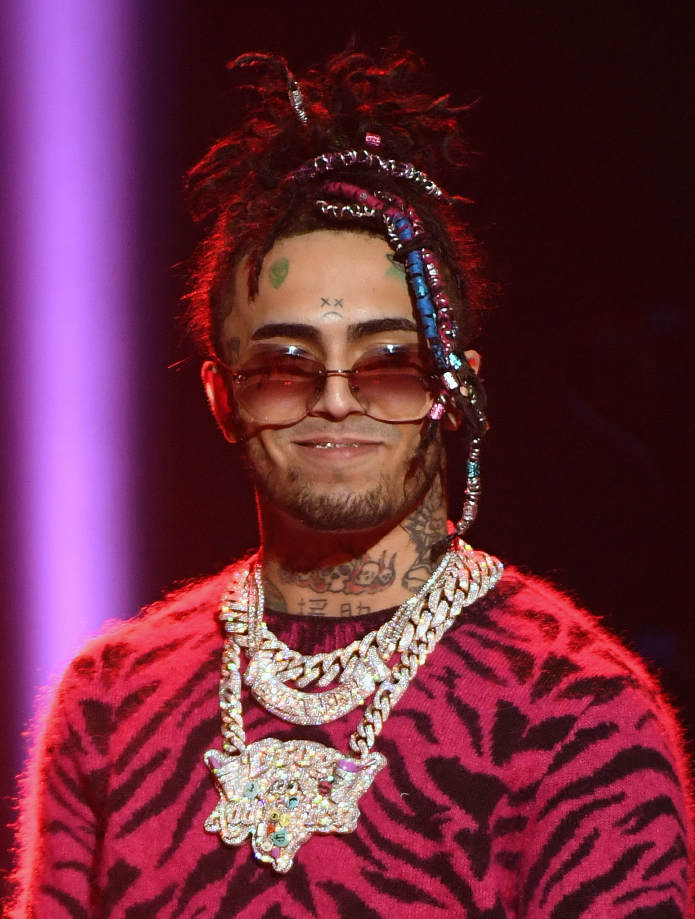 Lil Pump smiling while wearing several diamond chains