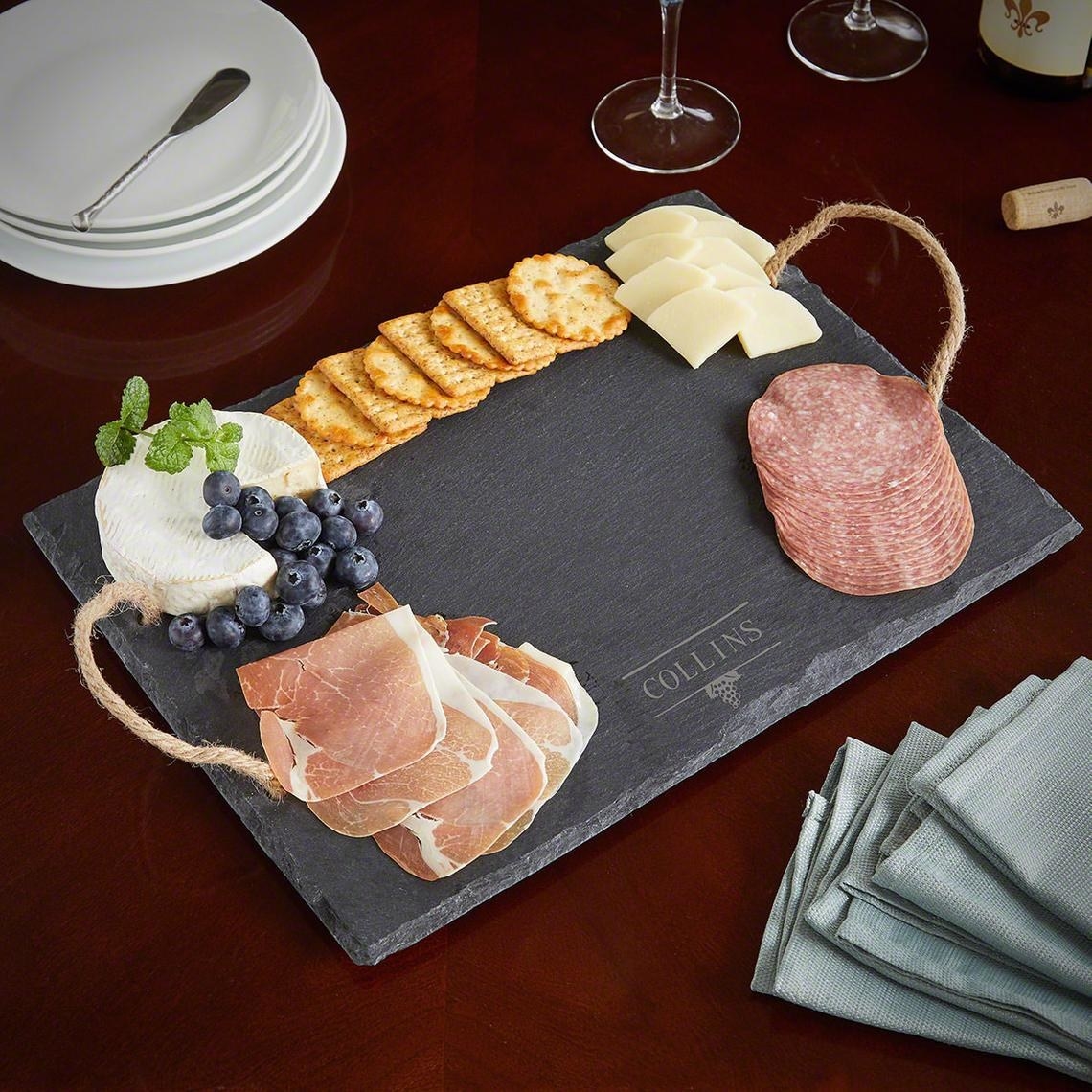 A charcuterie board with meat cheese crackers and fruit