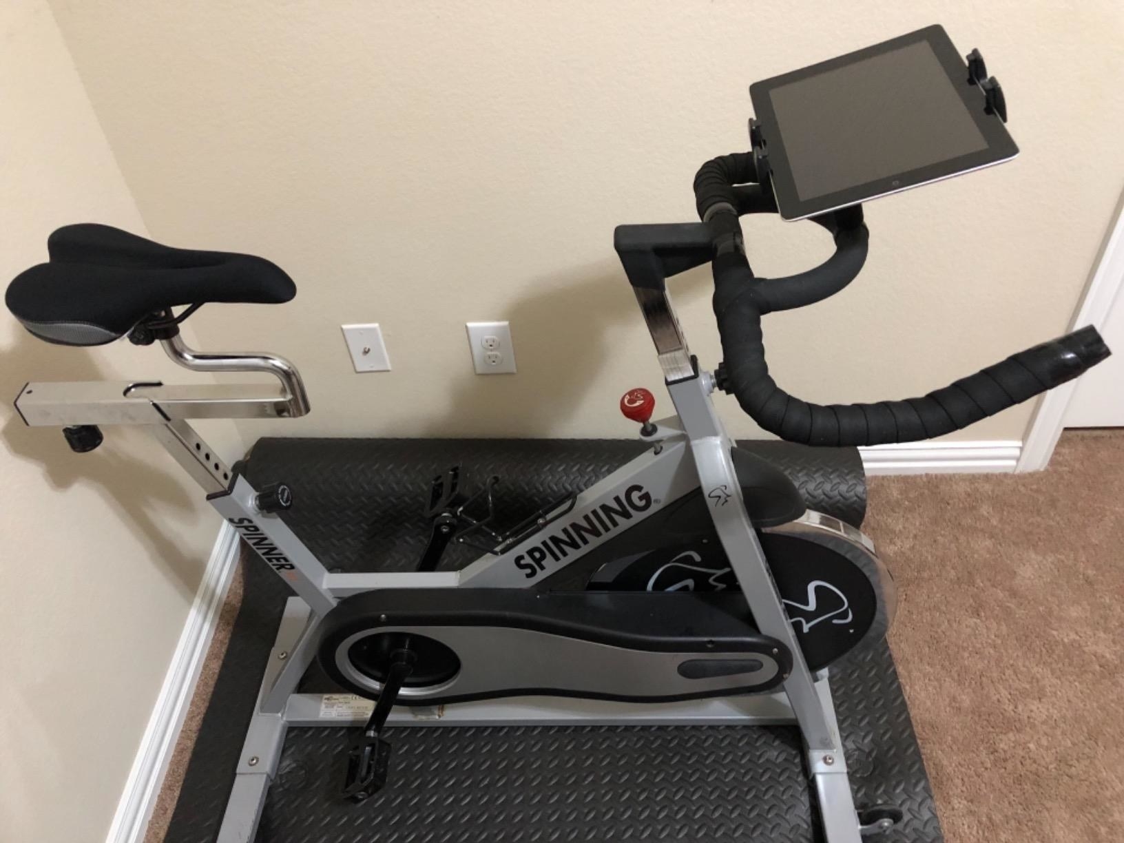 A reviewer&#x27;s home bike with a tablet attached