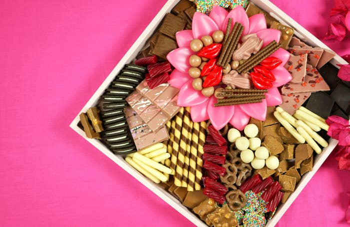 A platter with a bunch of different chocolates and sweets on it.