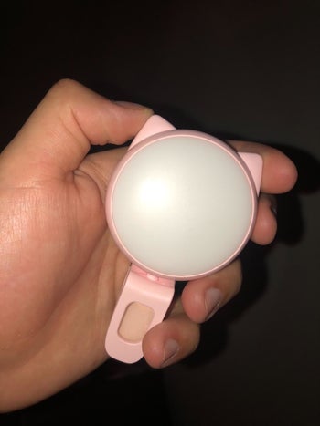 Reviewer holding the turned off light to show its size