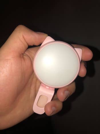 Reviewer holding the turned off light to show its size