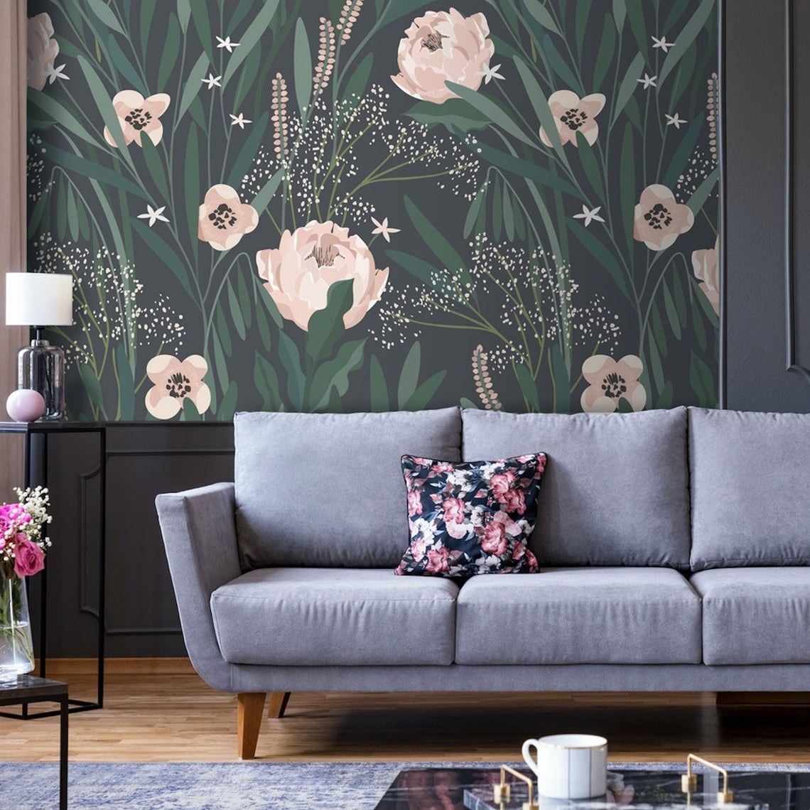 The wall behind a couch covered in the floral wallpaper