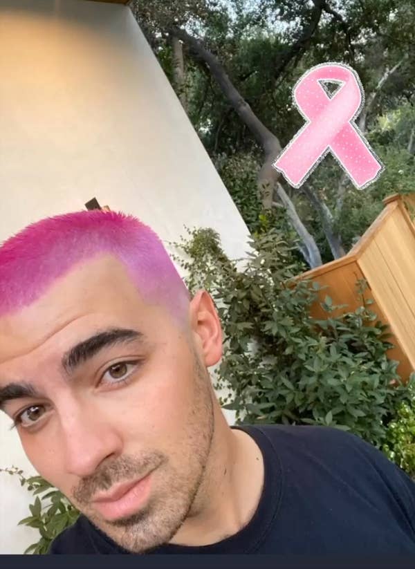 Joe's selfie, debuting his hot pink blond buzzcut with a pink ribbon sticker in the upper corner of the photo