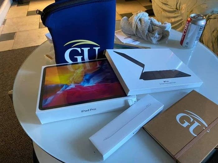 Image of an iPad Pro, GU iPad case, and other tech