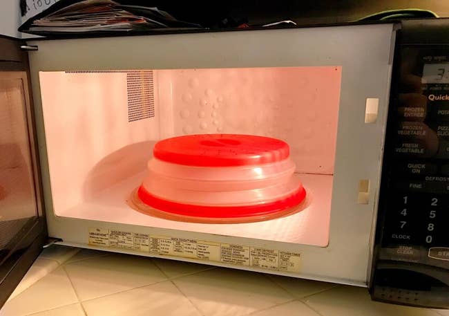 A reviewer's photo of the red microwave food cover