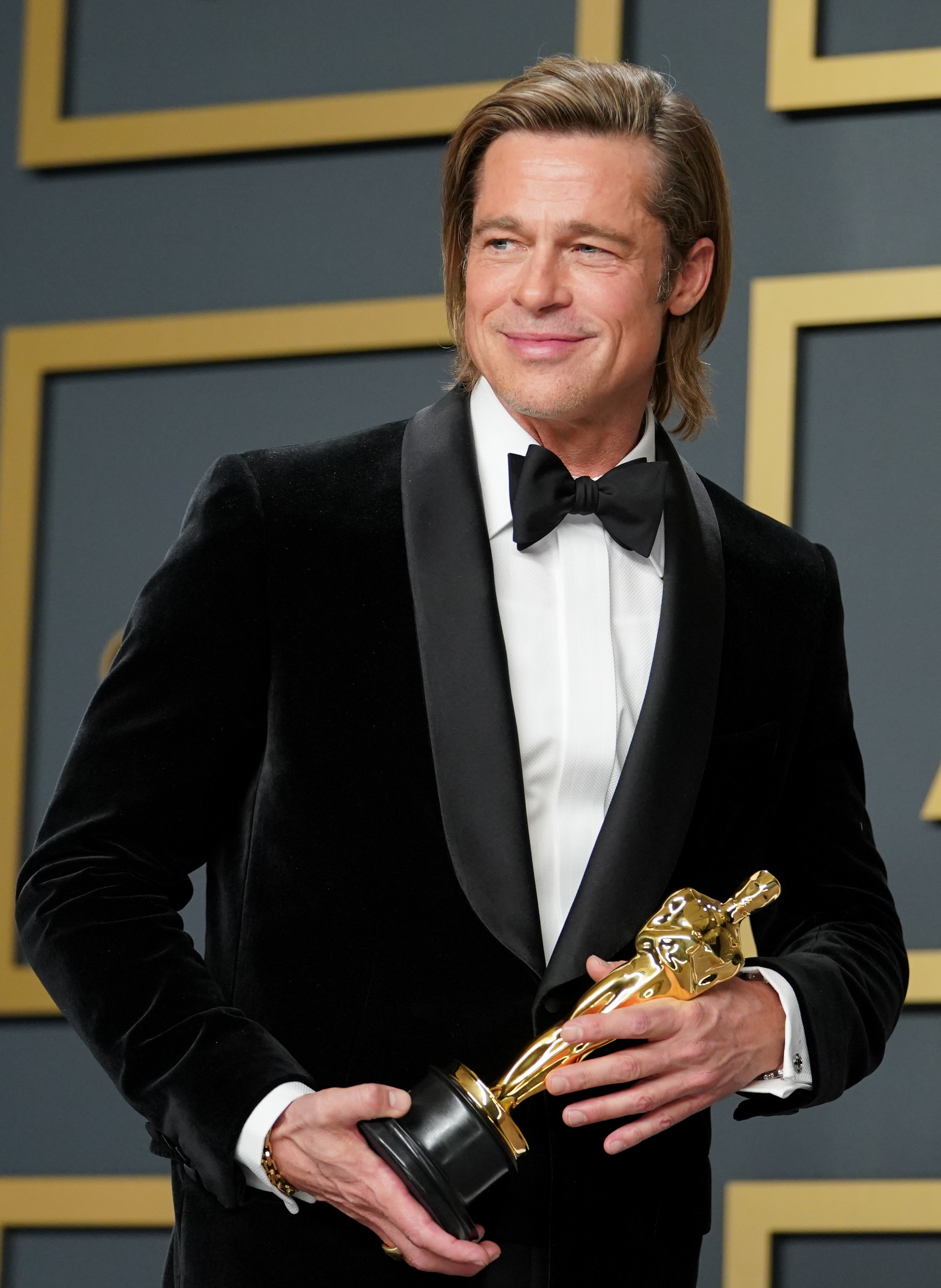 Brad Pitt posing with his Best Actor Oscar in 2020