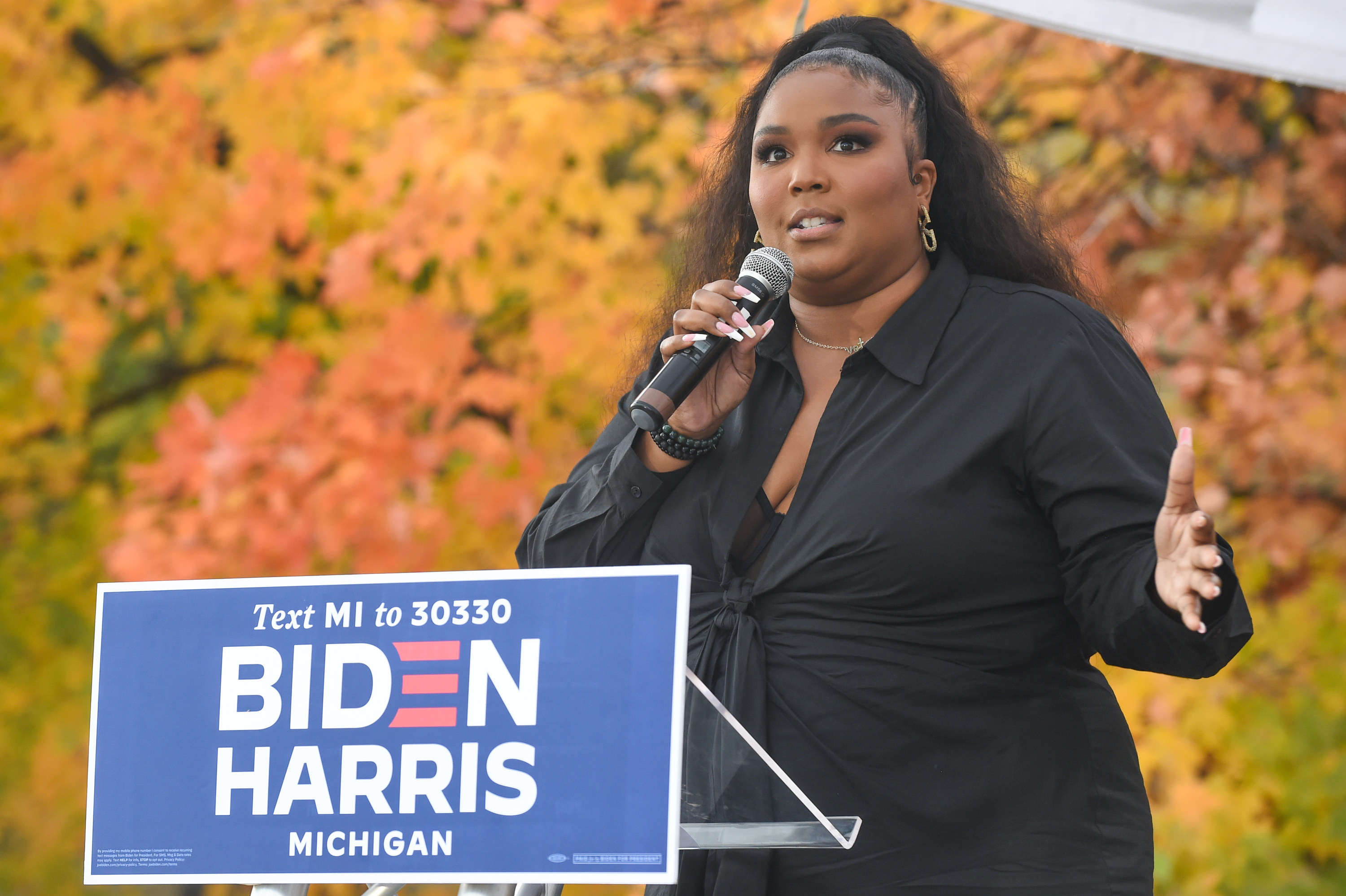 Lizzo speaking at a Michigan campaign event for Biden