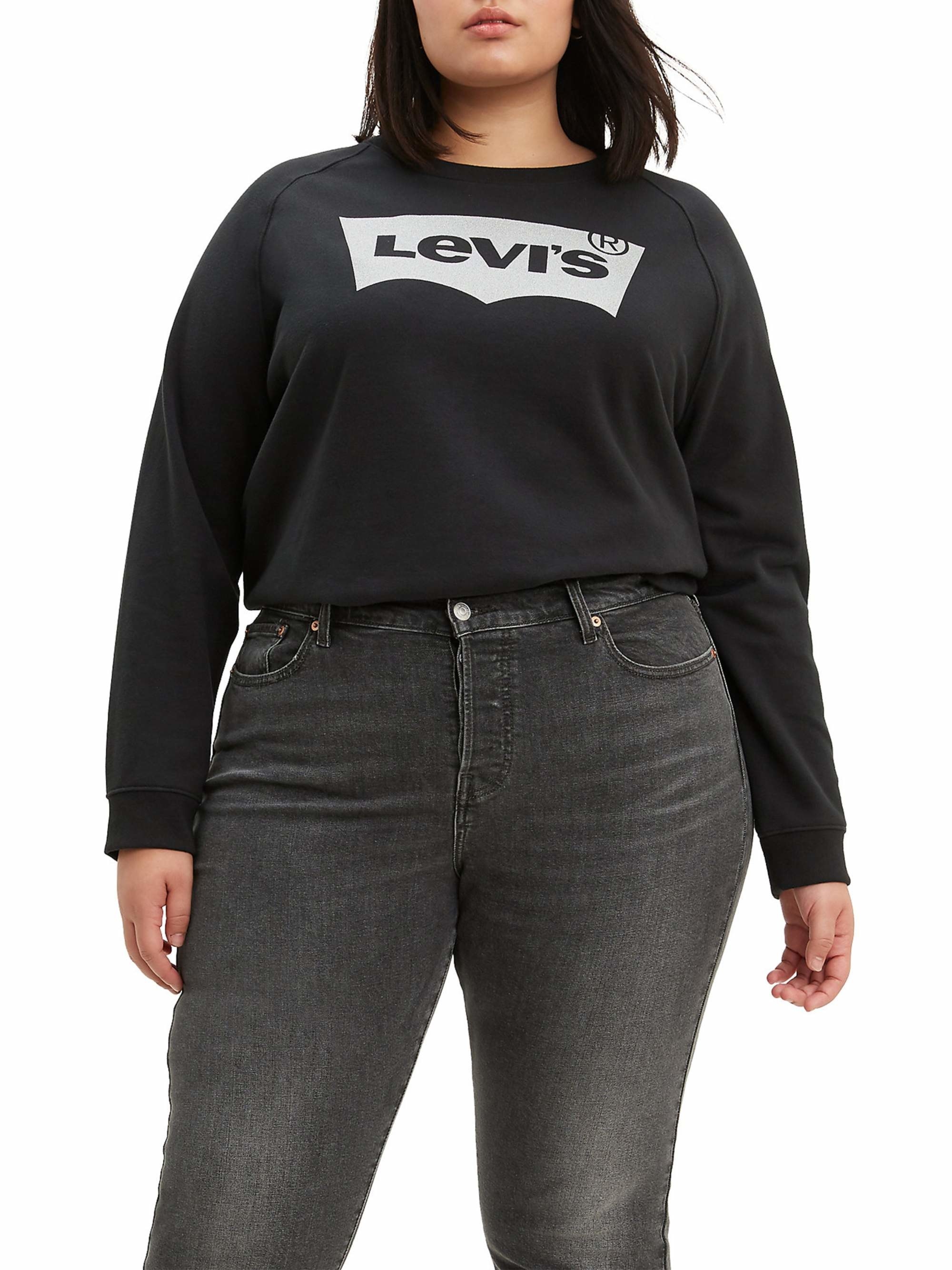 person wearing a black levi&#x27;s crewneck sweatshirt and black jeans