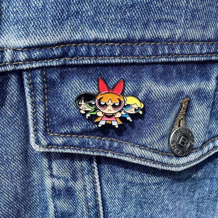 A Powerpuff Girls pin on a jean jacket