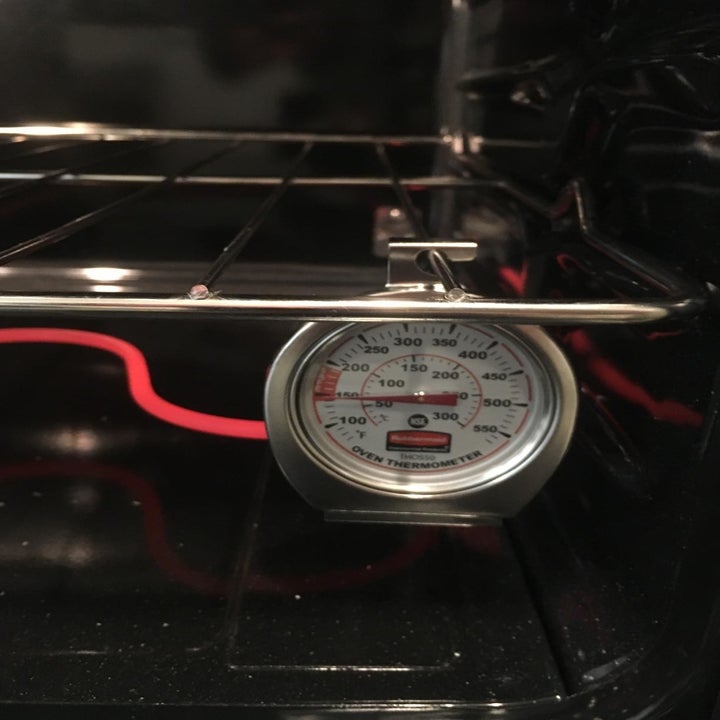 A reviewer's photo of the thermometer hanging in an oven