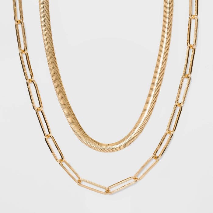 Gold chain necklace and shorter gold necklace together