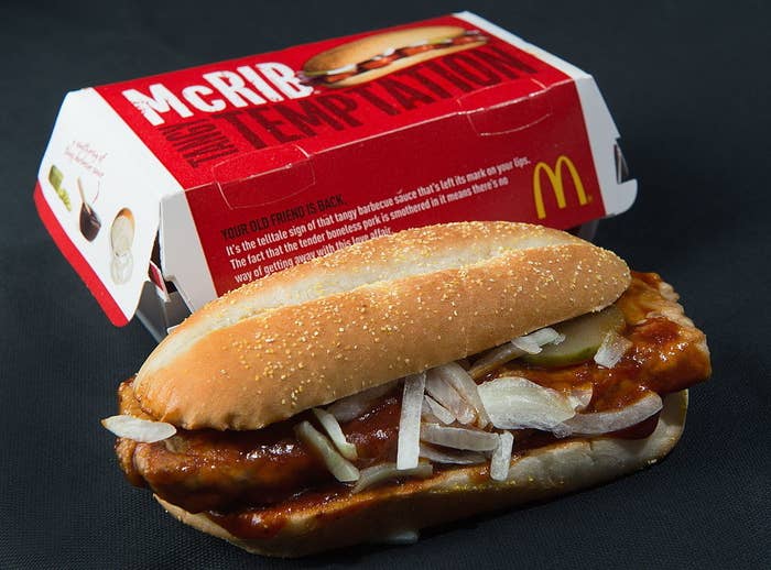 The McRib in front of its container which says &#x27;McRIB Tasty Temptation&#x27;