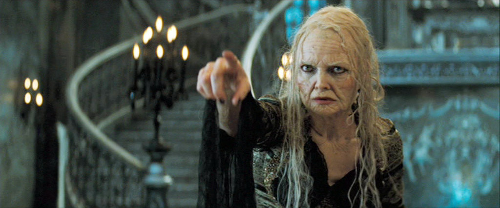 Michelle Pfeiffer as an aged witch casting a magical spell