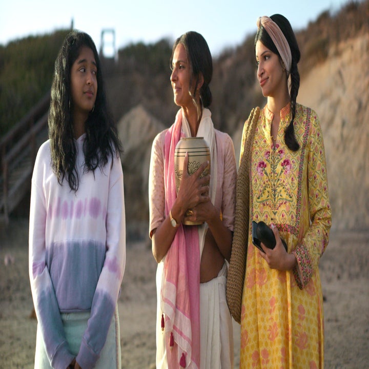 Devi, Kamala, and her mother stand on the beach holding her father's ashes