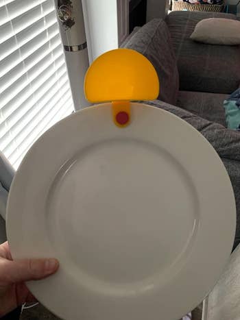 A yellow dip clip attached to a white plate