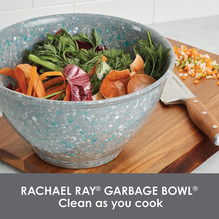 The grey blue speckled bowl holding vegetable scraps