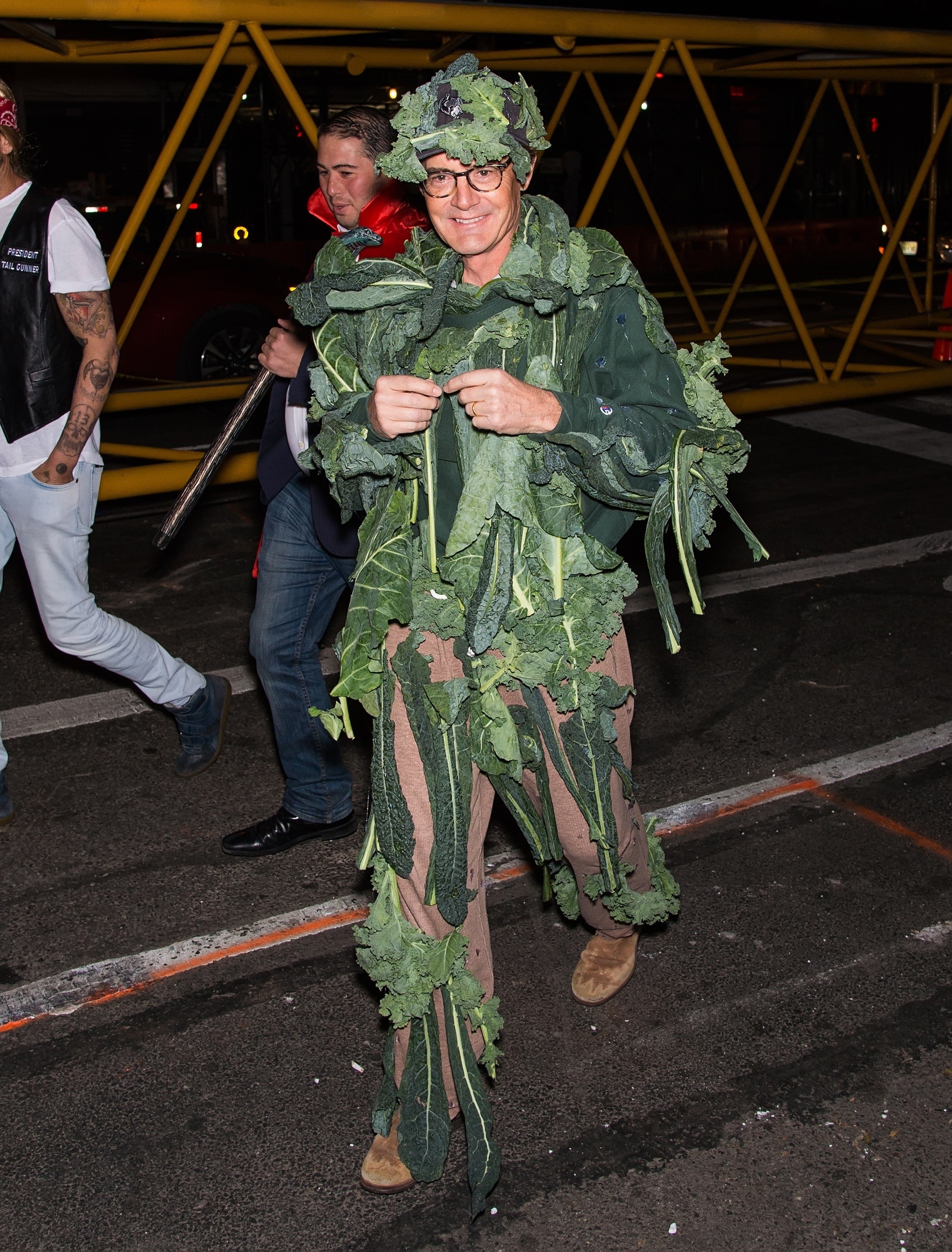 Kyle MacLachlan dressed in a suit with lots of kale pinned to it. 