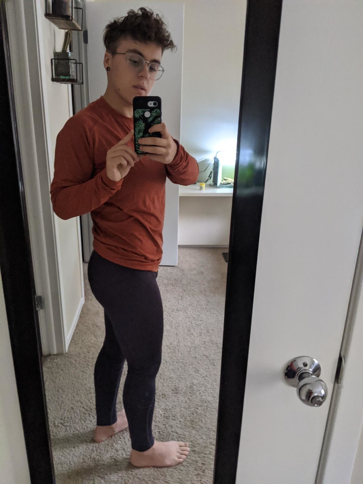 Reviewer wears black thermal compression leggings with a red running top